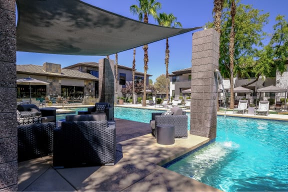 resort-inspired, covered lounging area and swimming pool at Avora apartments