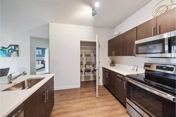 luxury kitchen with custom cabinetry and stainless steel appliances at Carrick Bend apartments