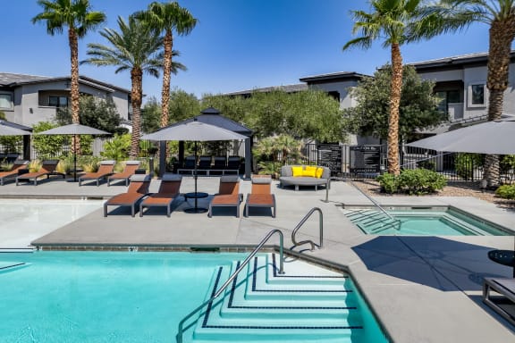 swimming pool  and poolside lounging areas at South Blvd apartments