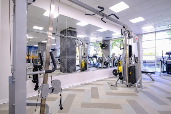 fitness center with weights and strength training equipment at Roosevelt Square apartments