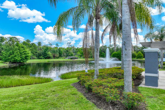 a lake with a fountain at The Reserves at Alafaya apartments