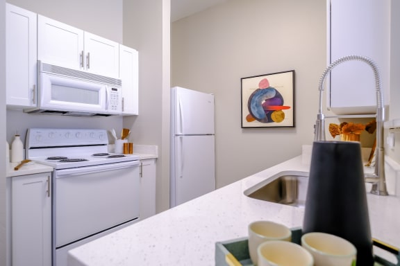 well appointed kitchen with modern white cabinetry at Roosevelt Square apartments in Phoenix