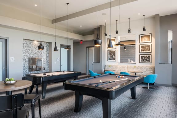 gaming lounge with billiards and shuffleboard at Tinsley on the Park apartments
