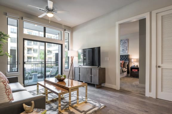 a living room with expansive windows at Tinsley on the Park apartments