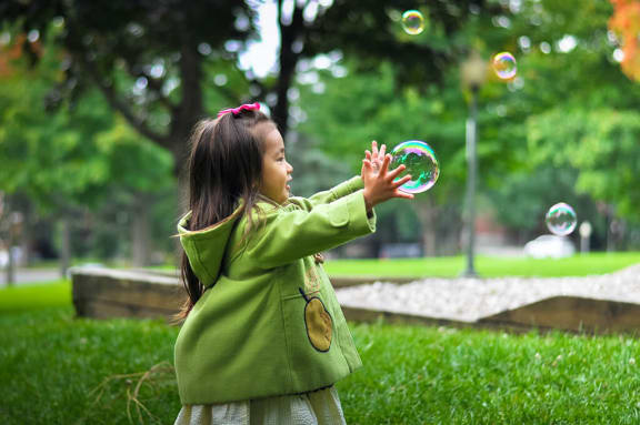 Girl at Playground with Bubbles at Ellington Metro West, Massachusetts