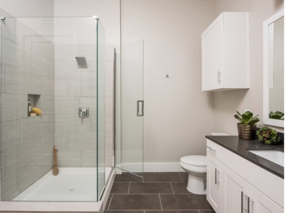 spacious bathroom with glass-framed shower at Tinsley on the Park apartments