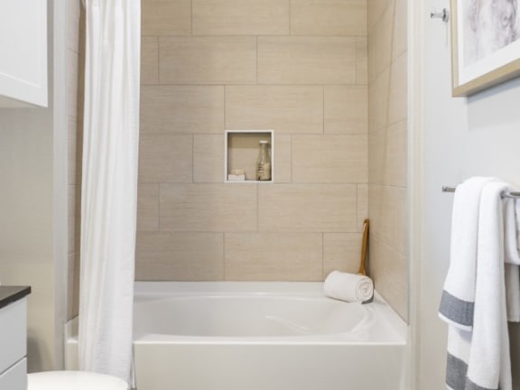 bathroom with soaking tub and tiled-tub surrounds at Tinsley on the Park apartments