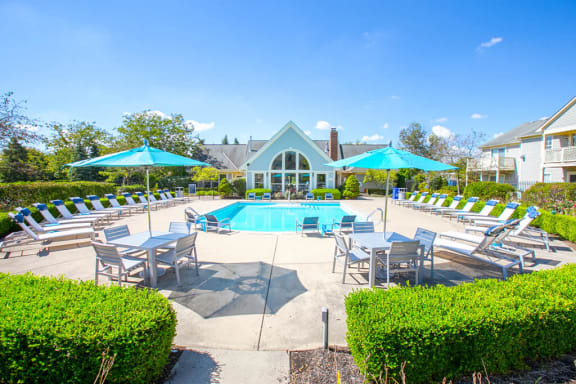 Poolside lounging and swimming pool at Perimeter Lakes apartments