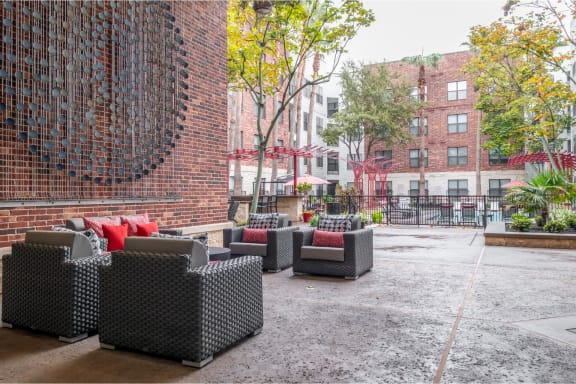 an outdoor patio with comfortable seating at The Core apartments