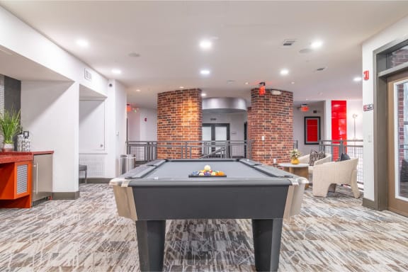 a game room with a pool table at The Core apartments