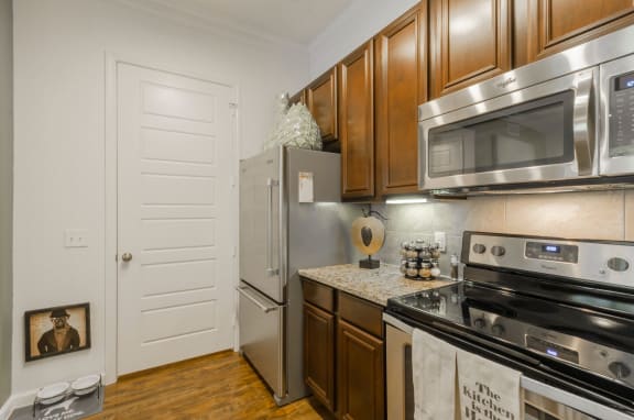 kitchen with wooden cabinets atRetreat at Wylie, Wylie, TX