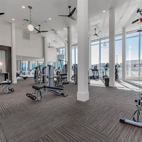fitness center with Dallas skyline views at The Gabriella apartments
