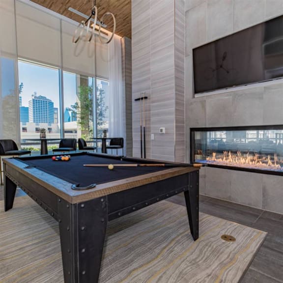 resident lounge with billiards, fireplace and a TV at The Gabriella apartments