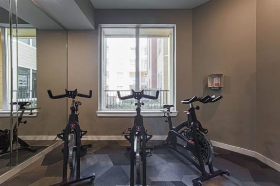 Fitness center with cardio equipment at Aspire at 610 apartments