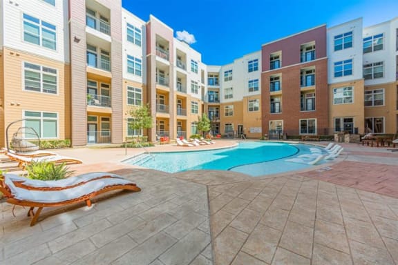 swimming pool with sun deck at Aspire at 610 apartments