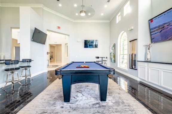 a game room with a pool table at Villages of Magnolia apartments