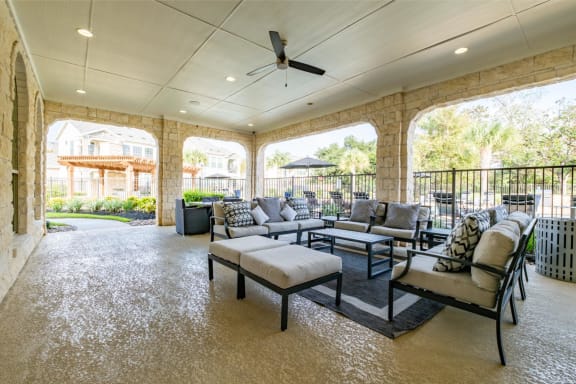 covered patio lounging area at Villages of Magnolia apartments