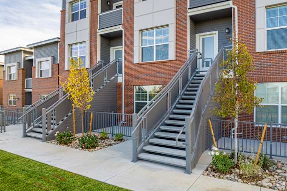 Set of exterior stairs leading to a door at Brownstones at Palisade Park, CO, 80023.