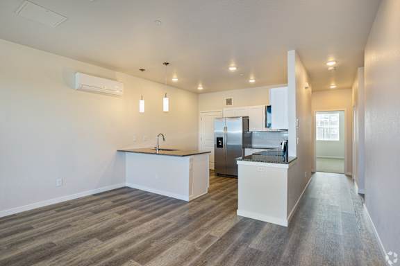 Kitchen with white cabinets and appliances at Brownstones at Palisade Park, Broomfield,