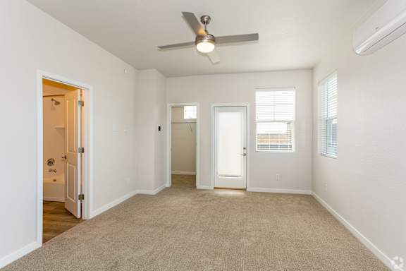 Spacious bedroom with a ceiling fan at Brownstones at Palisade Park, Broomfield,  Colorado.