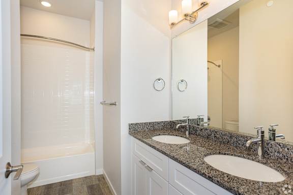Bathroom with a granite countertop and double sinks at Brownstones at Palisade Park,  Colorado.