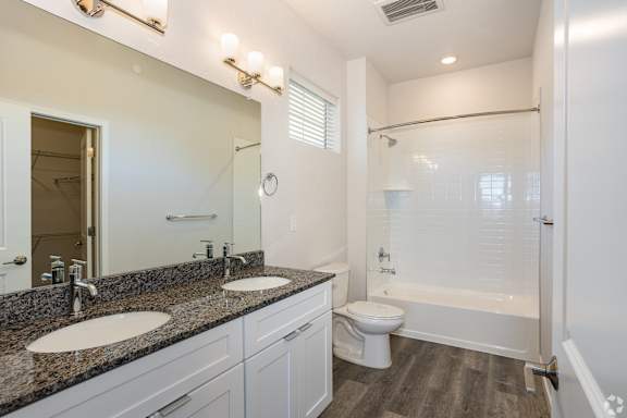 A bathroom with a sink, toilet, and bathtub.