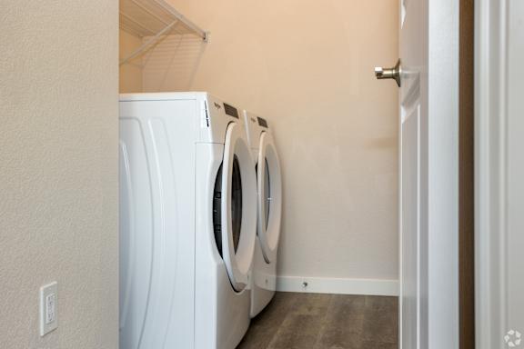 A white washing machine and dryer in a small laundry room.