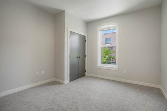 A room with a carpeted floor and a window at The Avenue Lofts Golden Apartments, Golden, CO