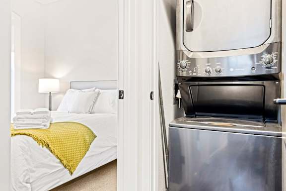 A bedroom with a bed and a built in oven at The Avenue Lofts Golden Apartments, Golden, Colorado