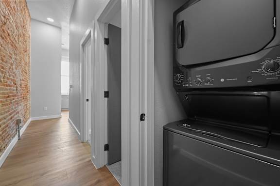 A black oven in a kitchen next to a white door at The Avenue Lofts Golden Apartments, Golden, CO, 80401