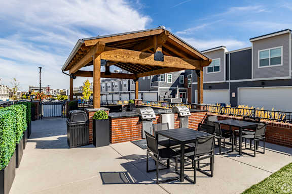 A wooden pergola is over a table set for four.