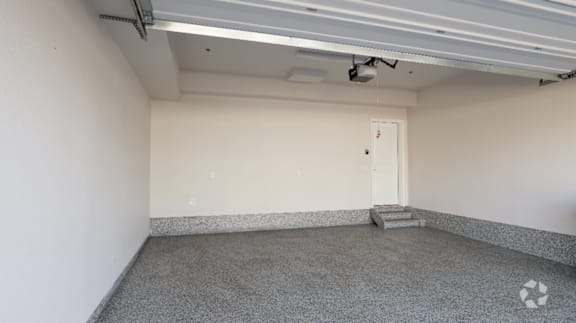 A room with a door and a staircase.