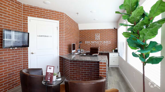 A living room with a brick wall and a television.