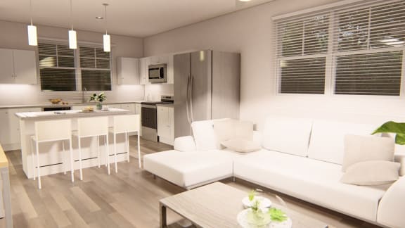 a small living room with a white couch and a kitchen in the background at Brownstones at Palisade Park Townhomes, Broomfield Colorado