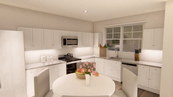 a kitchen with white cabinets and a white table and chairs at Brownstones at Palisade Park Townhomes, Broomfield Colorado