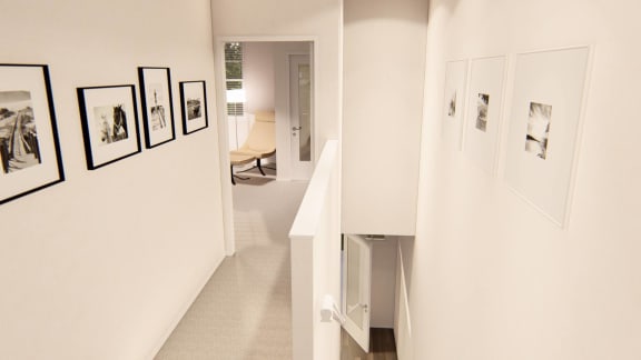 a hallway with white walls and pictures on the wall at Brownstones at Palisade Park Townhomes, Broomfield, CO