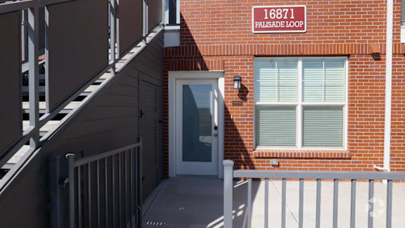 A building with a sign that says "16871 Palisade Loop".