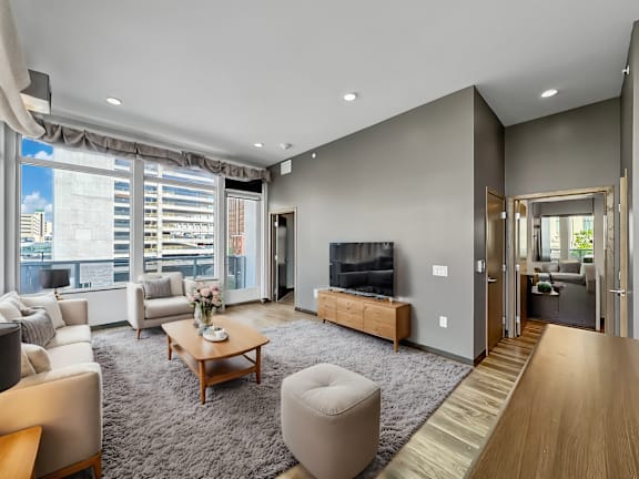 a living room with gray walls and a large window