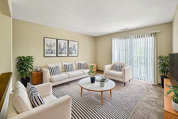 A living room with a white sofa set and a coffee table.
