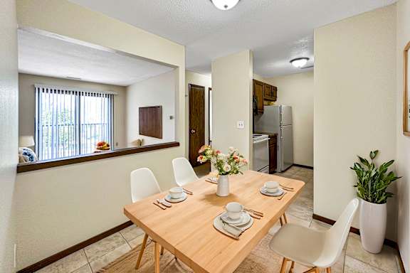 A dining room with a table set for two.
