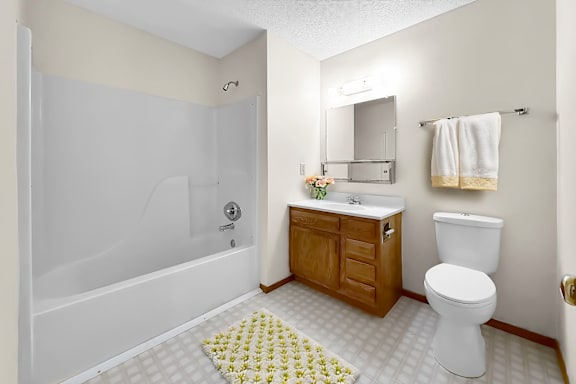 A white toilet sits next to a sink in a bathroom.