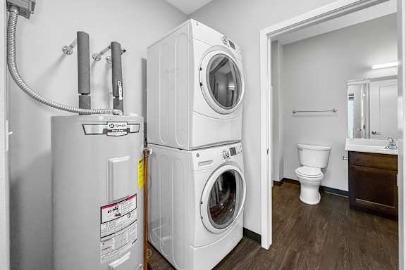 A small laundry room with a washer and dryer stacked on top of each other.