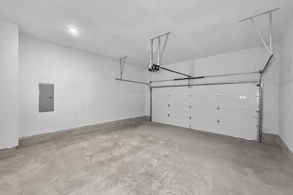 A white room with a basketball hoop and a white door.