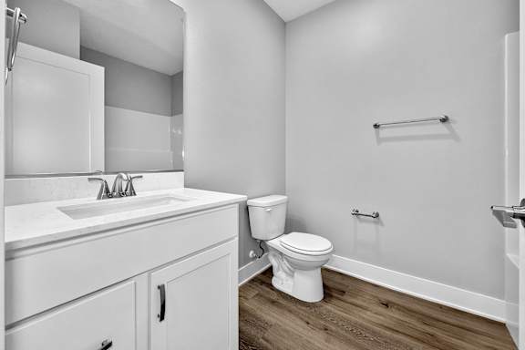A white bathroom with a toilet, sink, and cabinet.