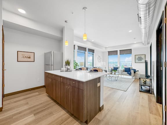 a kitchen with a large island and a living room