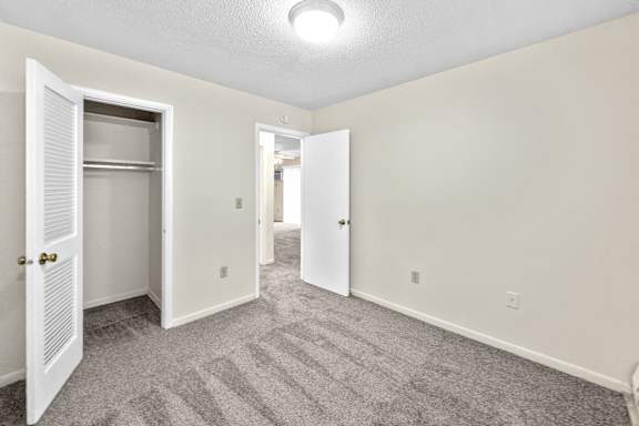 A room with a carpeted floor and white walls.