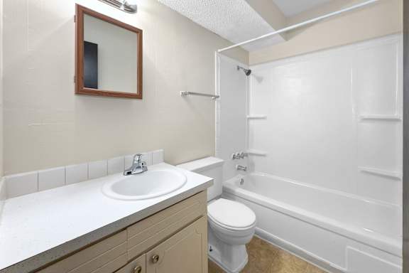 A white bathroom with a toilet and a sink.