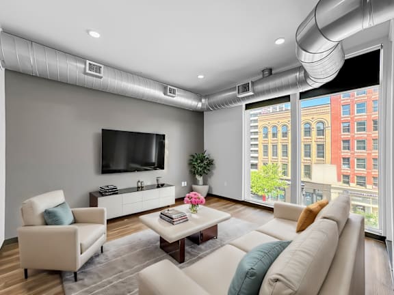 a living room with a couch and a coffee table and a television