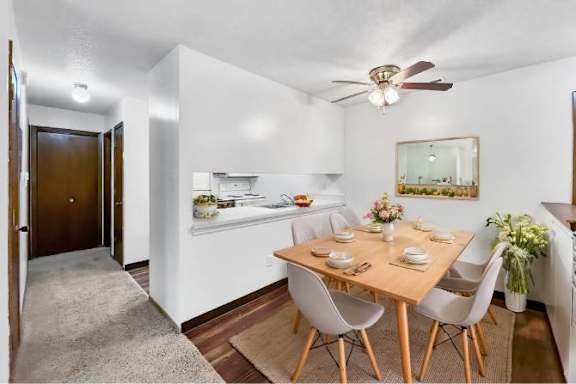 A dining room with a table set for four.