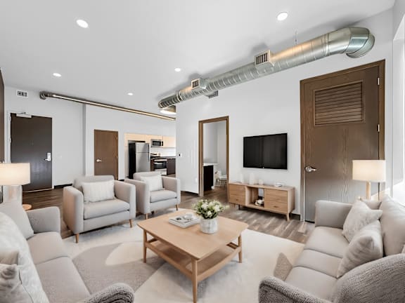 a living room with couches and chairs and a table